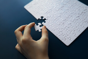 IQ development. Intellectual puzzles. The puzzle is empty. Brain training hand puts puzzle pieces together.