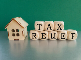 Tax relief symbol. Concept words 'tax relief' on wooden blocks on a beautiful green background....