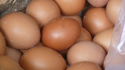a basket full of fresh chicken eggs at a traditional market stall just harvested a few hours ago from a chicken farmer