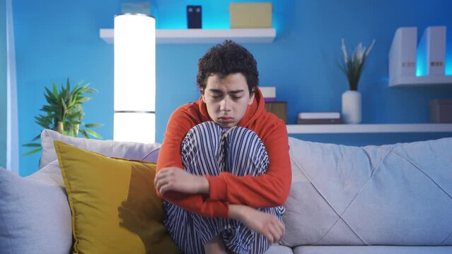 Depressed sad boy.
A young boy with psychological problems is not feeling well depressed at home.

