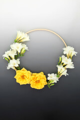 Summer wreath of rose freesia and freesia flowers. Beautiful natural round wooden frame floral...