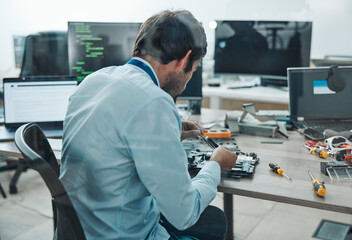 Man, it and technician fixing motherboard in engineering workshop for PC database update. Worker,...