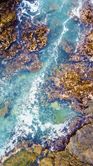 Aerial view of the sea rocks cliffs in the ocean. Beautiful sea wallpaper for tourism and advertising. Stormy landscape, drone photo