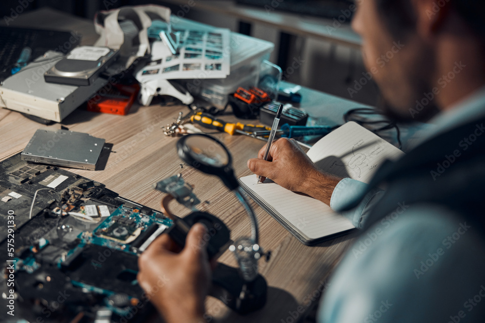 Poster technician, engineer or it man repair motherboard, circuit board or electronic device in workshop or