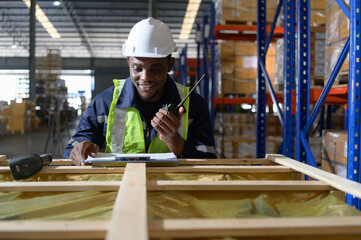 Fototapeta premium Head of worker in an auto parts warehouse, Examine auto parts that are ready to be shipped to the automobile assembly factory.
