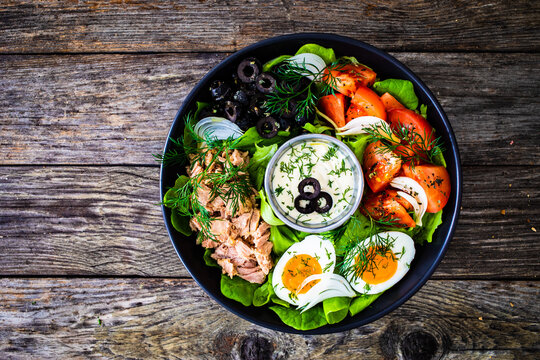 Nicoise salad - tuna, hard boiled eggs, greens, tomatoes and black olives
