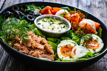 Nicoise salad - tuna, hard boiled eggs, greens, tomatoes and black olives
