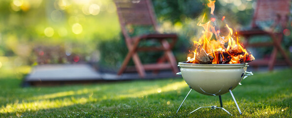 Barbecue grill with bright fire on open air. Camping - obrazy, fototapety, plakaty