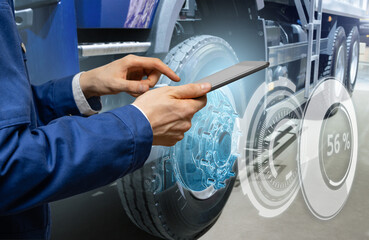 Serviceman repairing a truck using augmented reality application.	