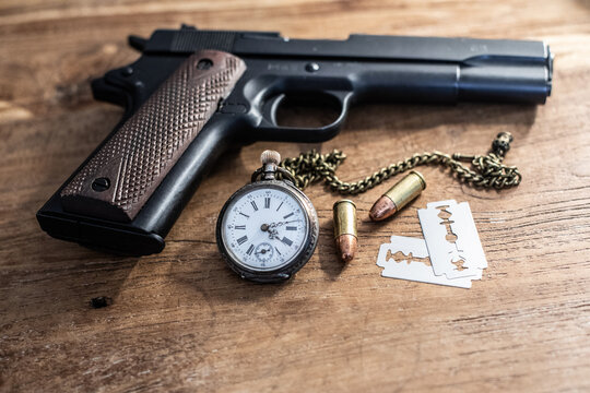 old pocket watch and gun