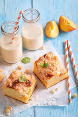 Delicious peach cake made of fruits. Served with milk.