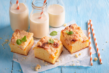 Homemade peach cake made of fruits. Served with milk.