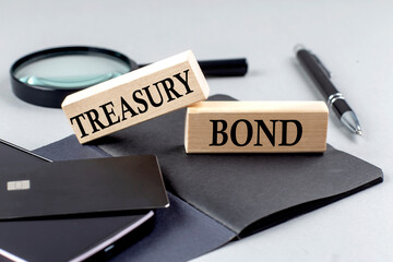 TREASURY BONDS text on wooden block on black notebook , business concept