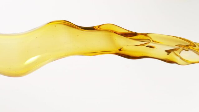 Super Slow Motion Shot of Flowing Oil on White Background at 1000fps.