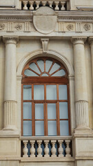 Fototapeta premium Close-up window and balcony view of a classical French building, Wooden window frame