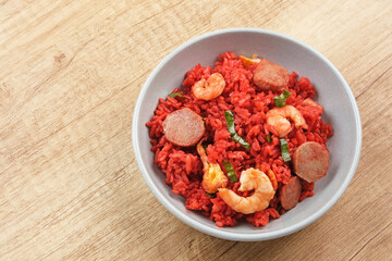 Nasi Goreng Merah, traditional food from Makassar, Indonesia. Fried rice with tomato sauce, shrimp, meatballs and egg. 
