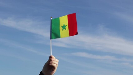 Senegal flag in hand flutters in the wind against the sky, independence national day of Senegal, country freedom, patriotism, Public Holiday, patriotic festival