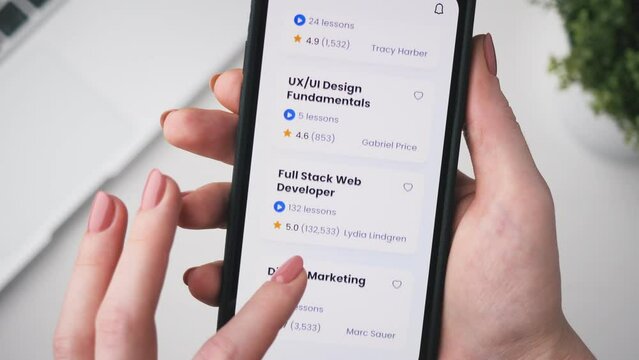 Woman enrolling into an coding online course. Checking full stack web development online course using app for mobile phone.