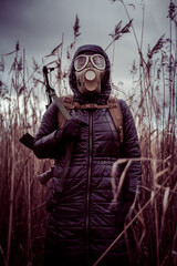 Person with rifle and gasmask in bushes - obrazy, fototapety, plakaty