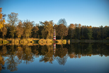 Fototapeta na wymiar Autumn lake with lighthouse 
