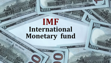 IMF - acronym on the background of cash dollar bills