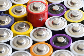 many round batteries and one red battery	