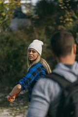 Confused blonde girl looking back at her friend