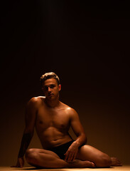 Fototapeta premium Handsome male at the studio sitting