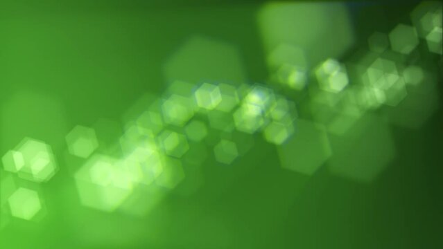 Defocused green bokeh lights background. This elegant motion animation with hexagonal bokeh particles is full HD and a seamless loop. Suitable as an abstract St Patrick's Day background.