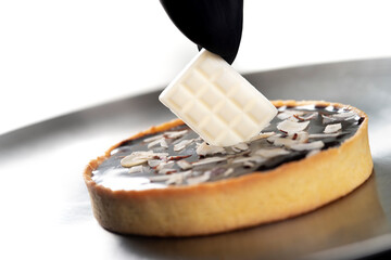 closeup view of the chef decorating the cake