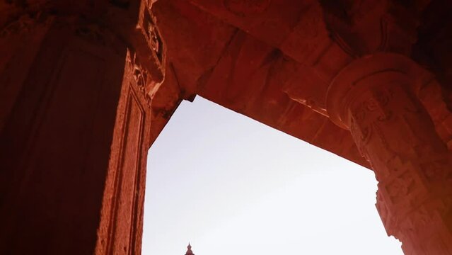 ancient hindu temple pillar architecture with back lit temple from different angle at day