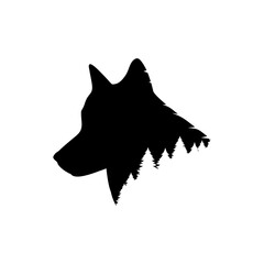 Black profile of a wolf's head against a forest background
