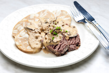 beef meat with mushroom sauce and dumplings