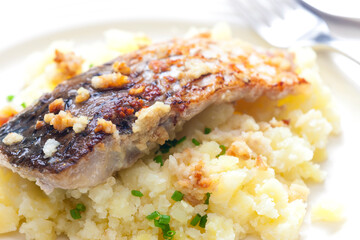 grilled carp with garlic served with mashed potatoes