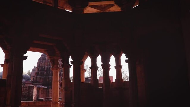 backlit red stone ancient hindu temple architecture from unique angle at day