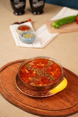 Turkish Traditional Soup with bread on dark rustic wooden background, kelle, paca corbasi. 