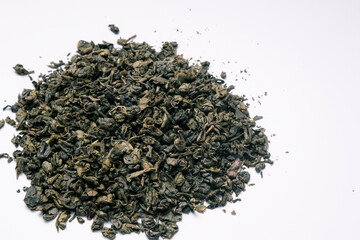 Close-up of dry green tea on white background. Top view. Close up.