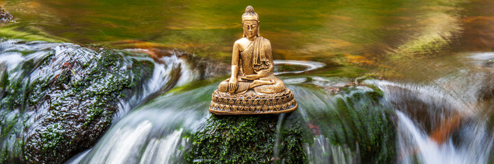 Buddha sculpture sitting in flowing water