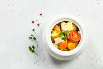 Turkey,stewed vegetables in ceramic pot. Top view, copy space.