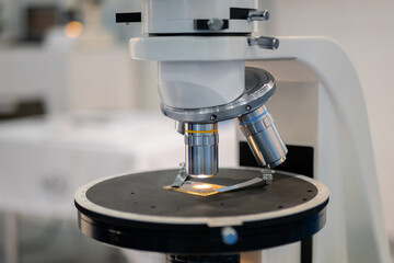 Objective lenses of white optical microscope - close up. Science, biology, optical, laboratory equipment and education concept