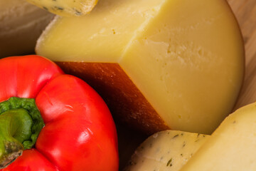 Bosnian traditional cheese served on a wooden container with peppers, parade and onions isolated on a white background