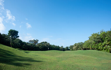 Golf in harmony with nature on a course nestled in the tropical forest against the blue sky in Mexico