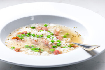 broth of smoked meat with green peas and rice