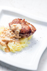 grilled meat with mashed potatoes with onion sauce