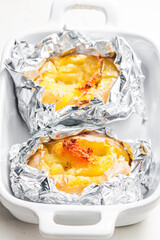 potatoes baked with cheese in aluminium foil