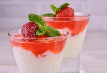 Rice pudding with strawberry jam on a white background.Close-up.
