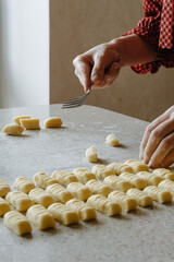 person preparing dough for gnocchi