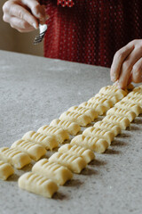 person preparing dough for gnocchi