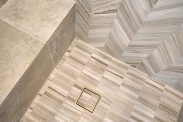 Detail of tile wall, bench and floor in a contemporary shower - 575340702