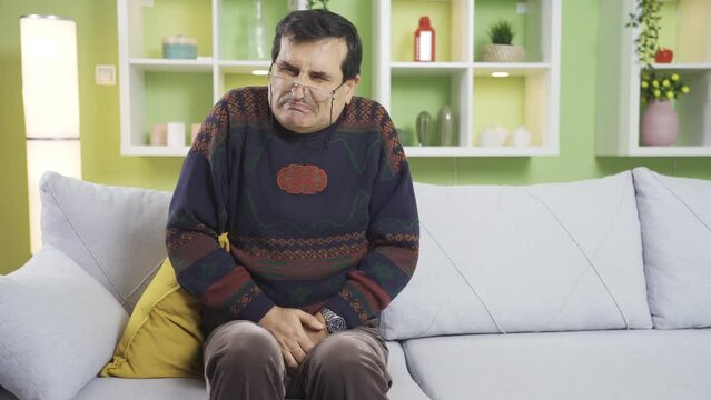Old man with prostate disease has trouble incontinence at home.
Mature prostate man has to go to the toilet frequently because of his discomfort at home.
